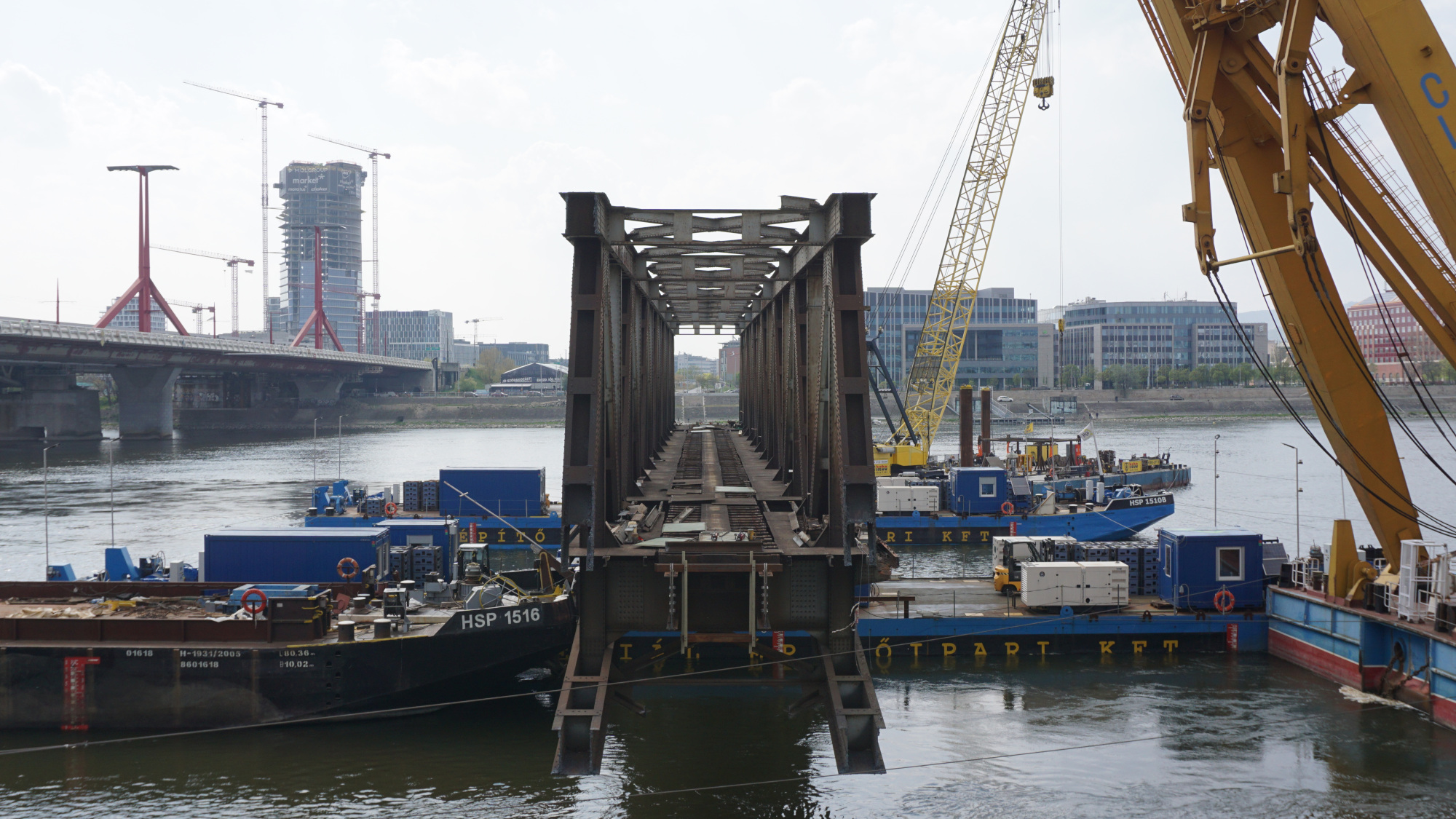 part of a dismantled bridge on barges
